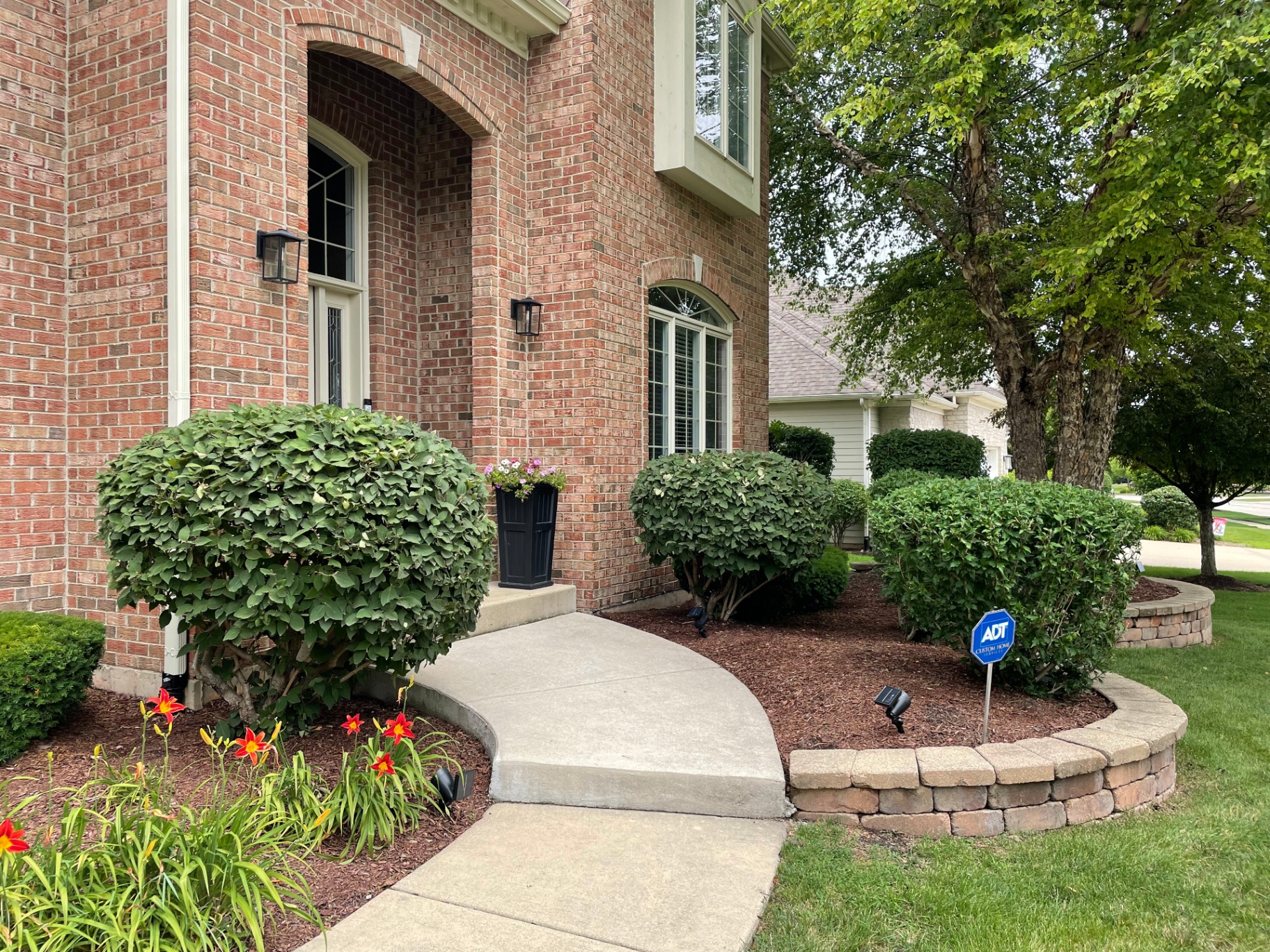Manicured front entrance landscaping